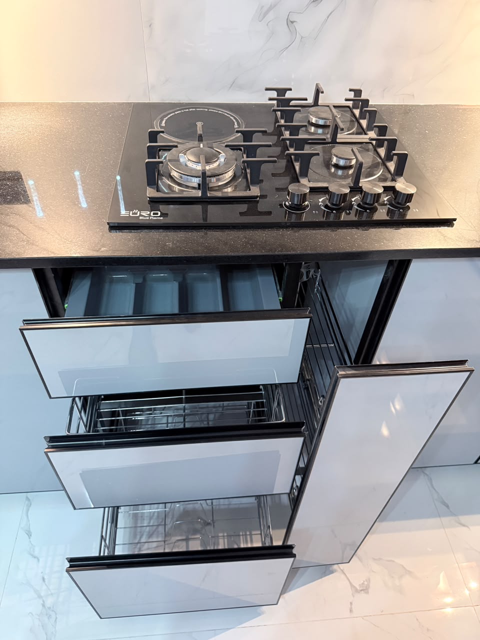 White kitchen with fluted island and LED display shelves